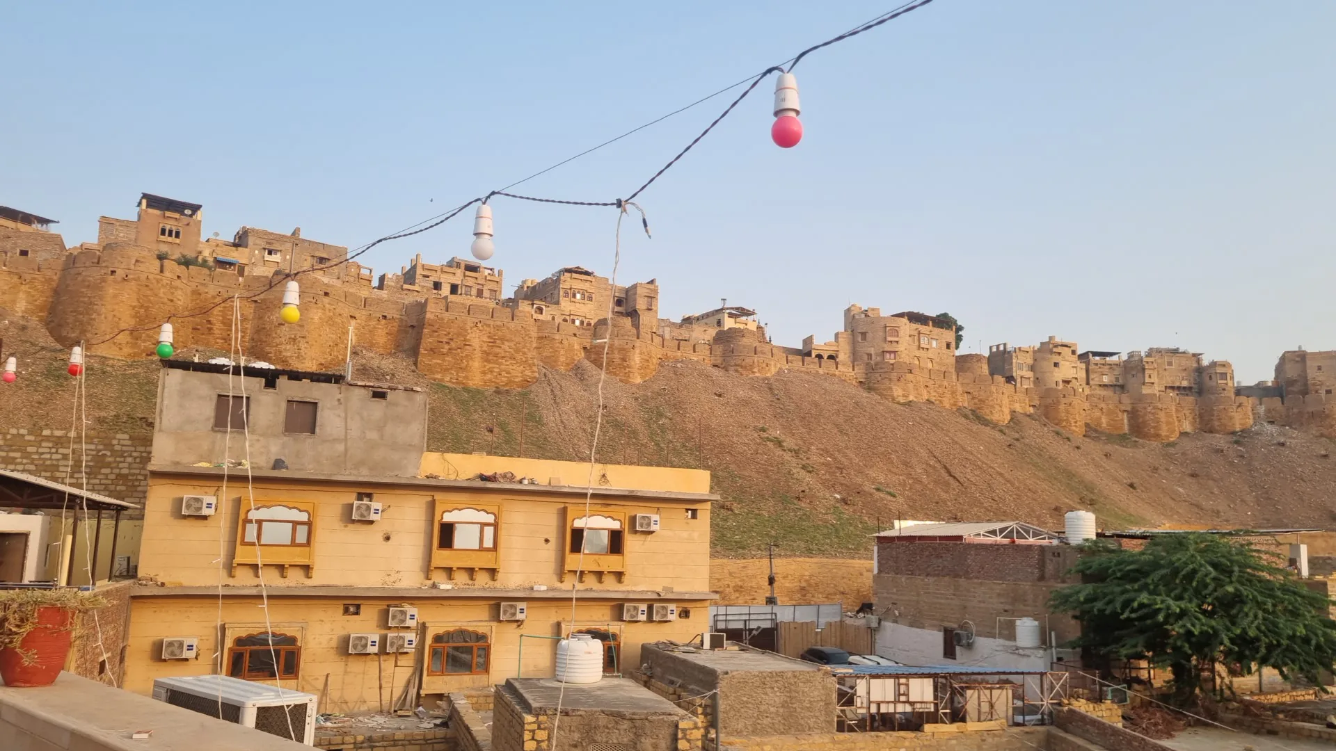 The hotel from the lane below, with the fort wall on the ridge directly behind it